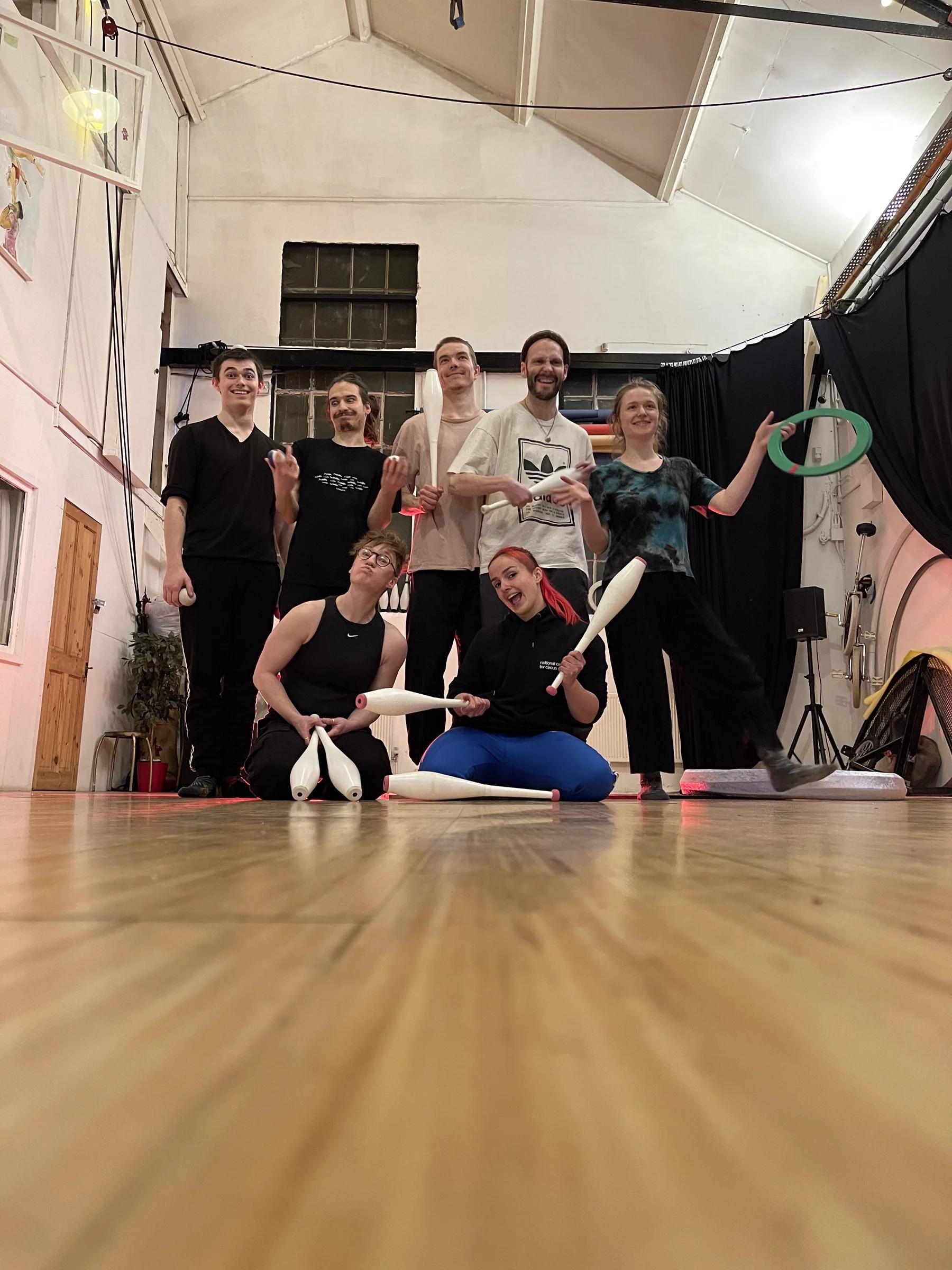 Jugglers posing with clubs, balls and rings after a session.